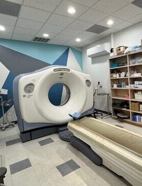 A CT scanner in a modern medical imaging room.